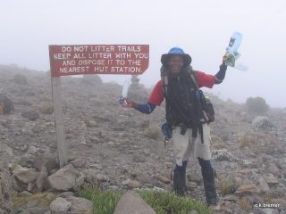 SENE guide picking up trash on Kilimanjaro